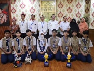 Tim robotik SMP PGRI 2 Ciledug menunjukkan piala dan penghargaan usai meraih juara nasional dalam kompetisi Robot for Mission 2026 di Bandung.