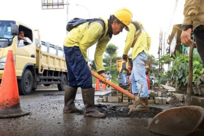 Petugas Dinas PUPR Kota Tangerang melakukan perbaikan jalan menggunakan material hotmix di salah satu ruas jalan prioritas untuk meningkatkan kenyamanan dan keselamatan pengguna jalan.